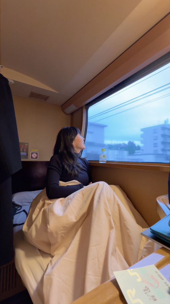 Enjoying the morning view from bed in a Sunrise Express Single cabin on the way to Tokyo