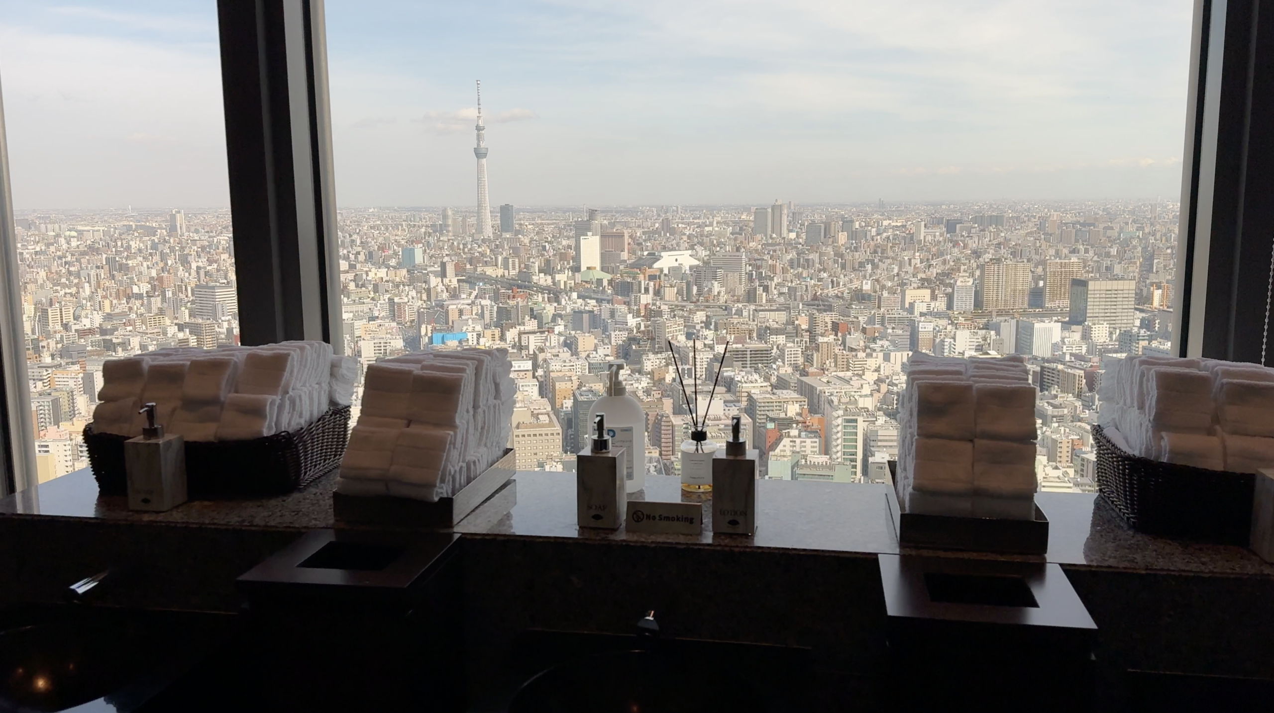 Tokyo Skytree and the skyline beyond the sinks in the hotel guest restroom at Mandarin Oriental Tokyo