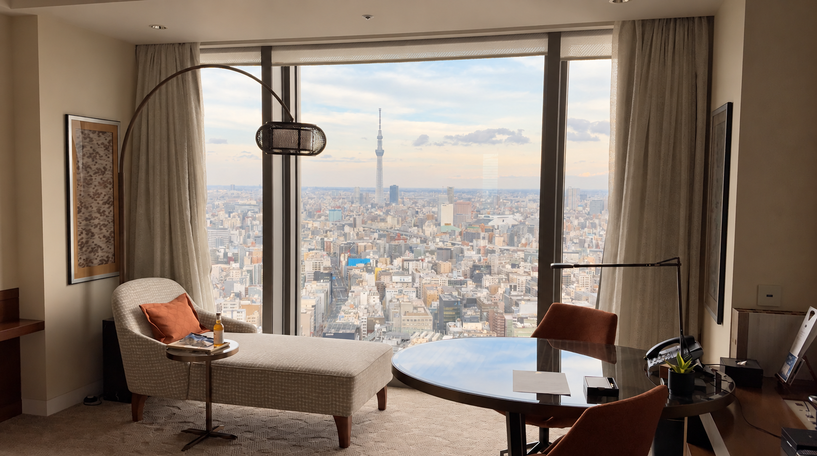 Lounge chair and desk beside windows overlooking Tokyo Skytree at Mandarin Oriental, Tokyo