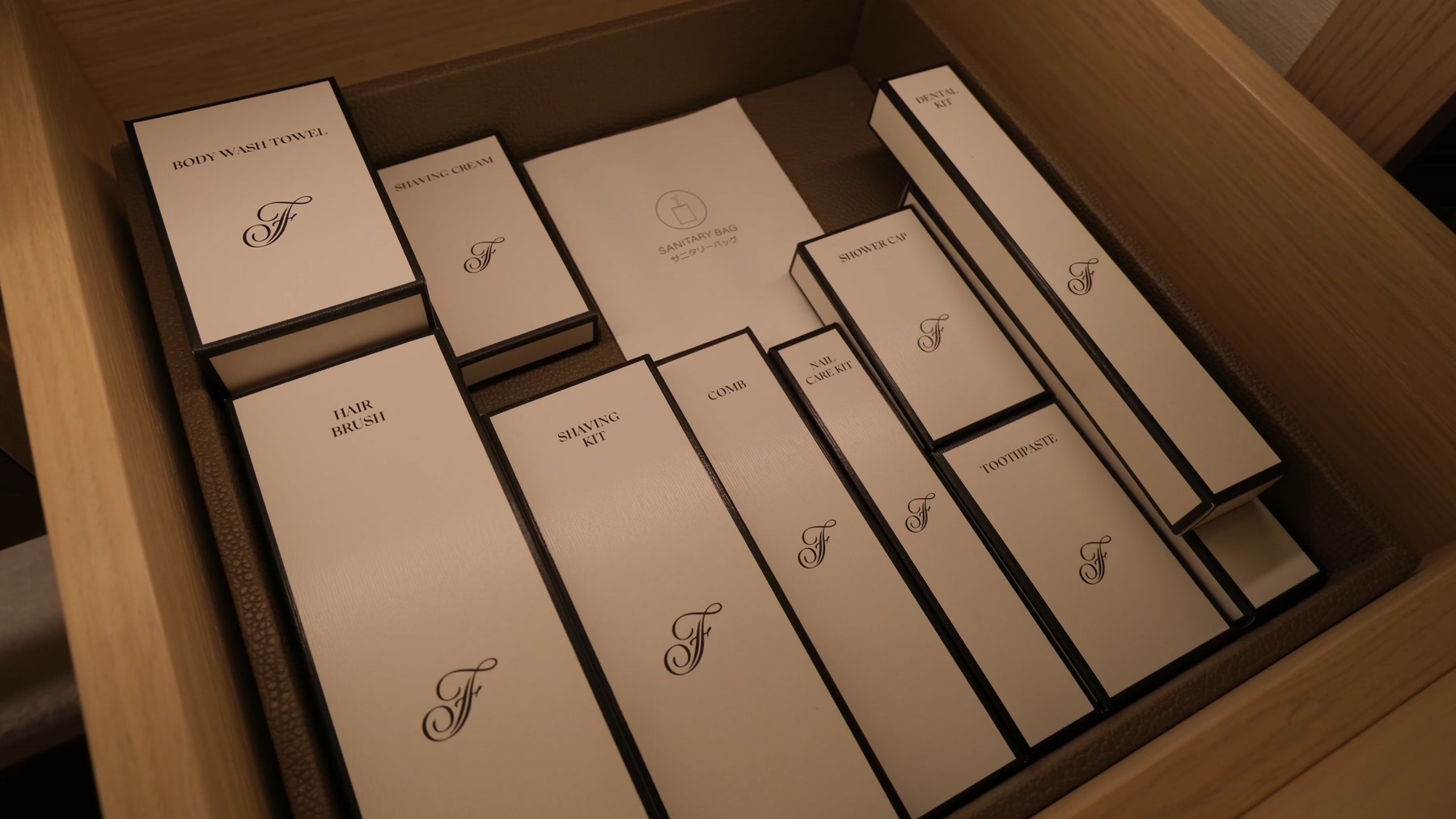Neatly arranged Fairmont-branded toiletries and grooming kits in the bathroom drawer