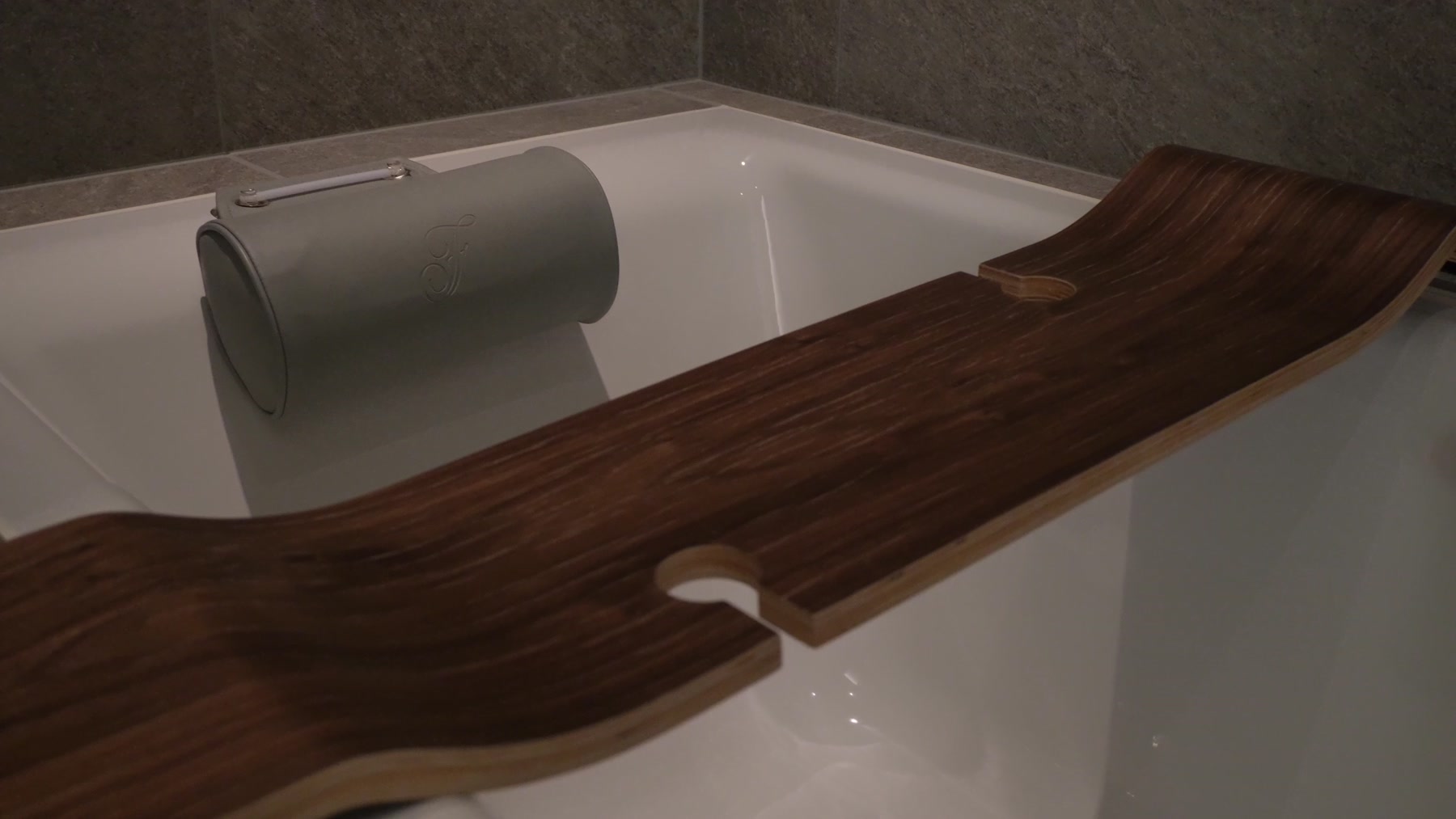 Bathtub with a wooden bath tray in the Fairmont Tokyo room