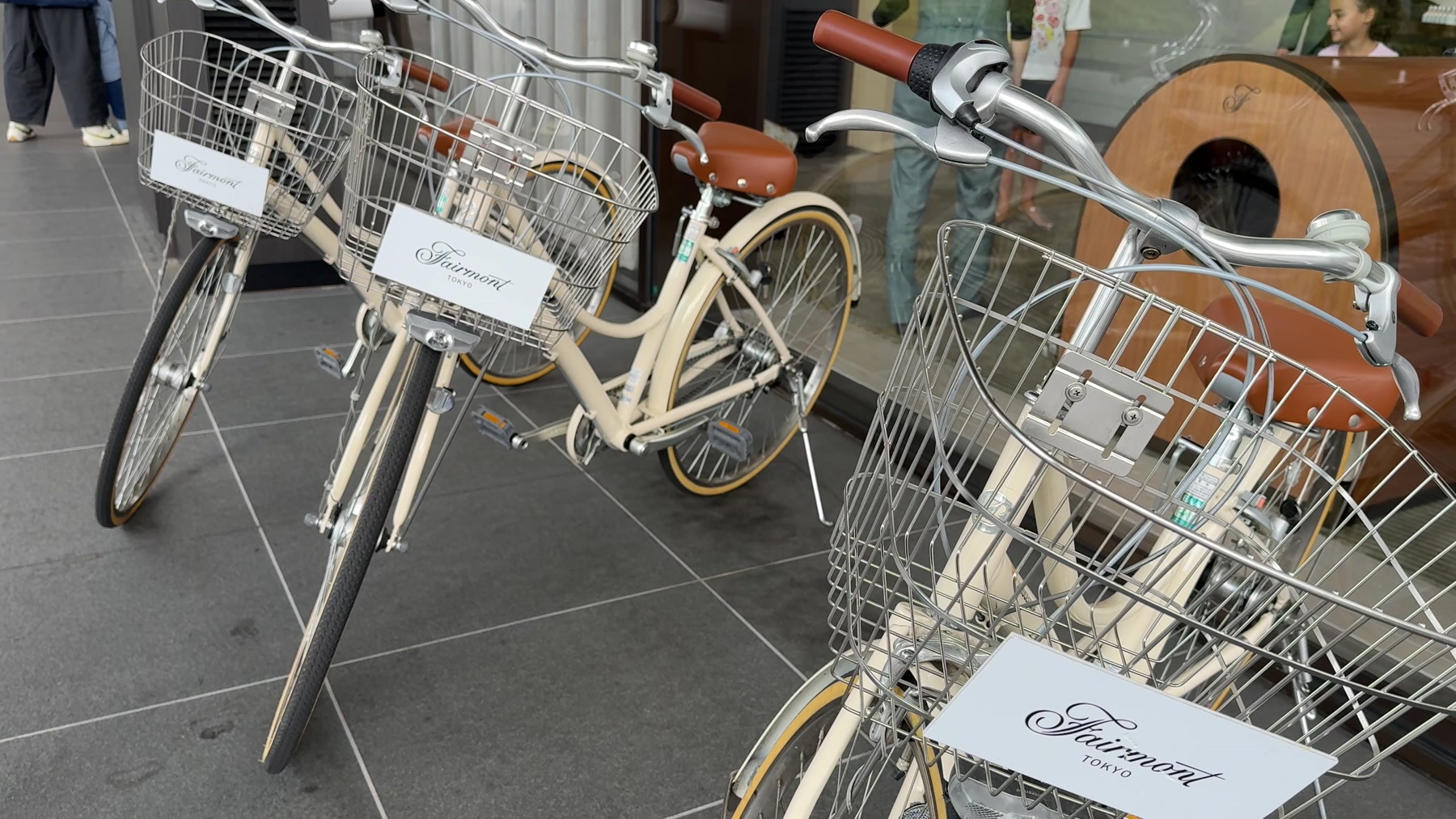 Cream-colored Fairmont Tokyo rental bicycles with baskets