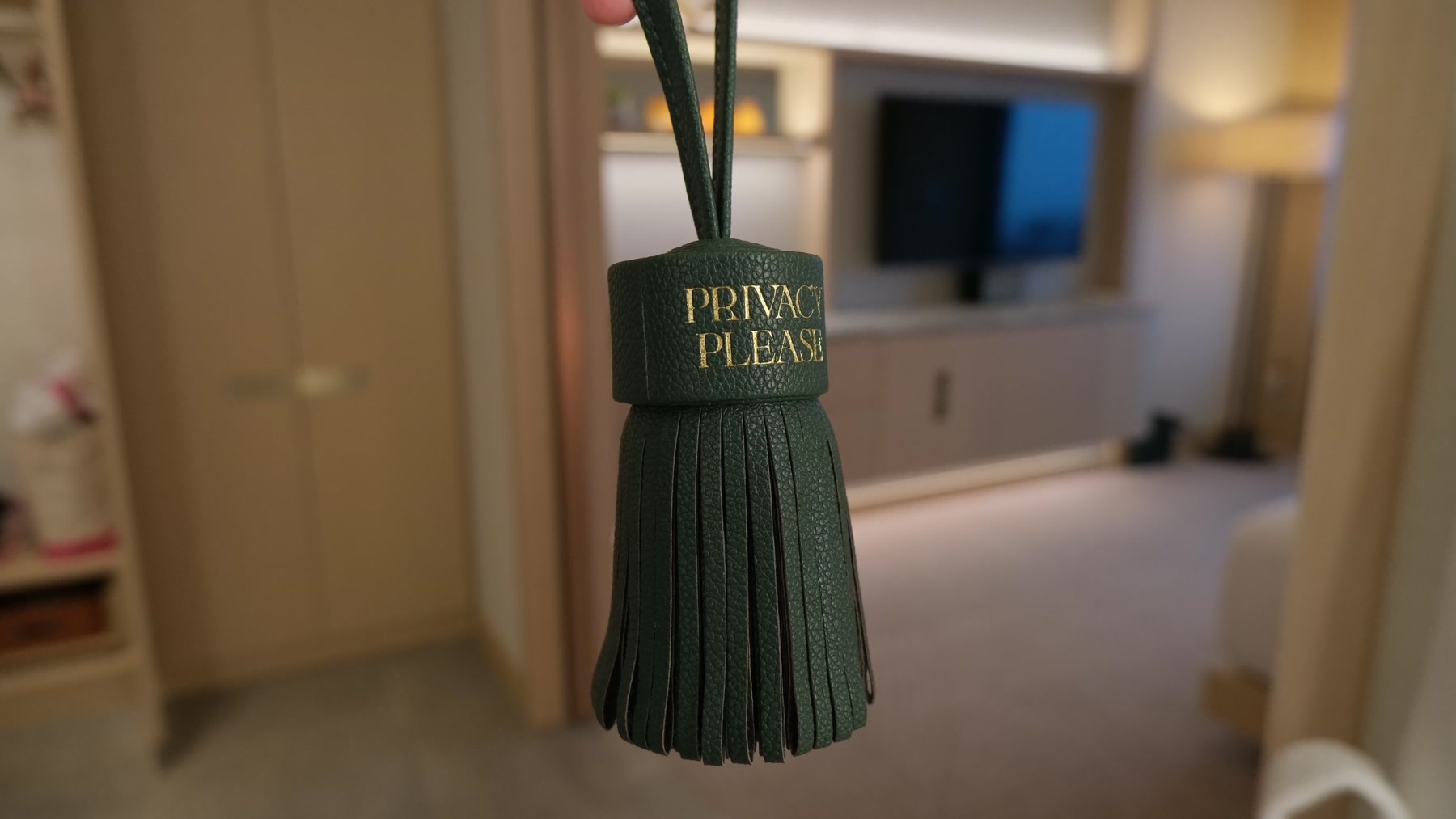 Green tasseled Privacy Please door hanger in our Fairmont Tokyo room