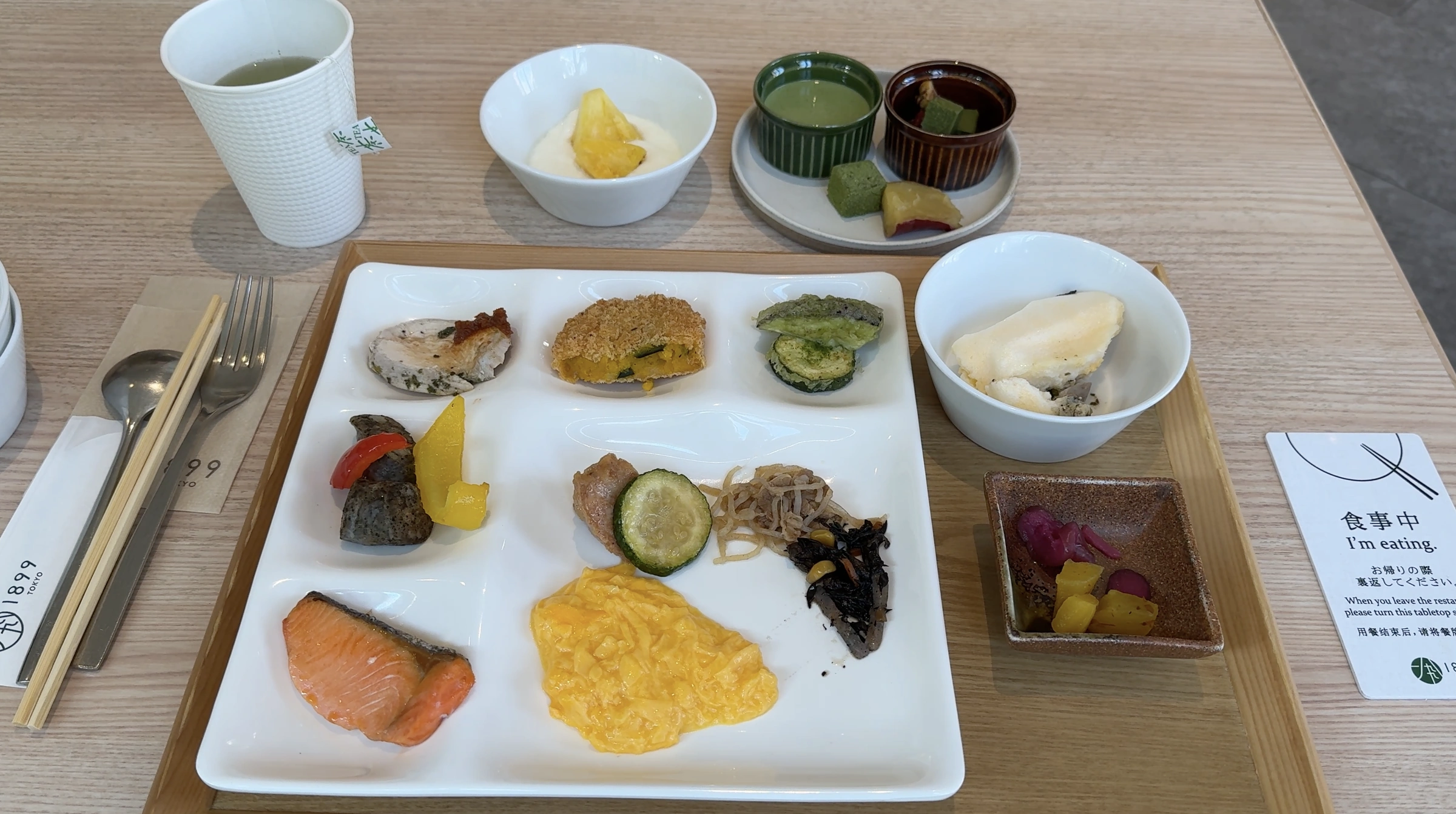 A breakfast plate with salmon, eggs, vegetables and small dishes at Hotel 1899 Tokyo