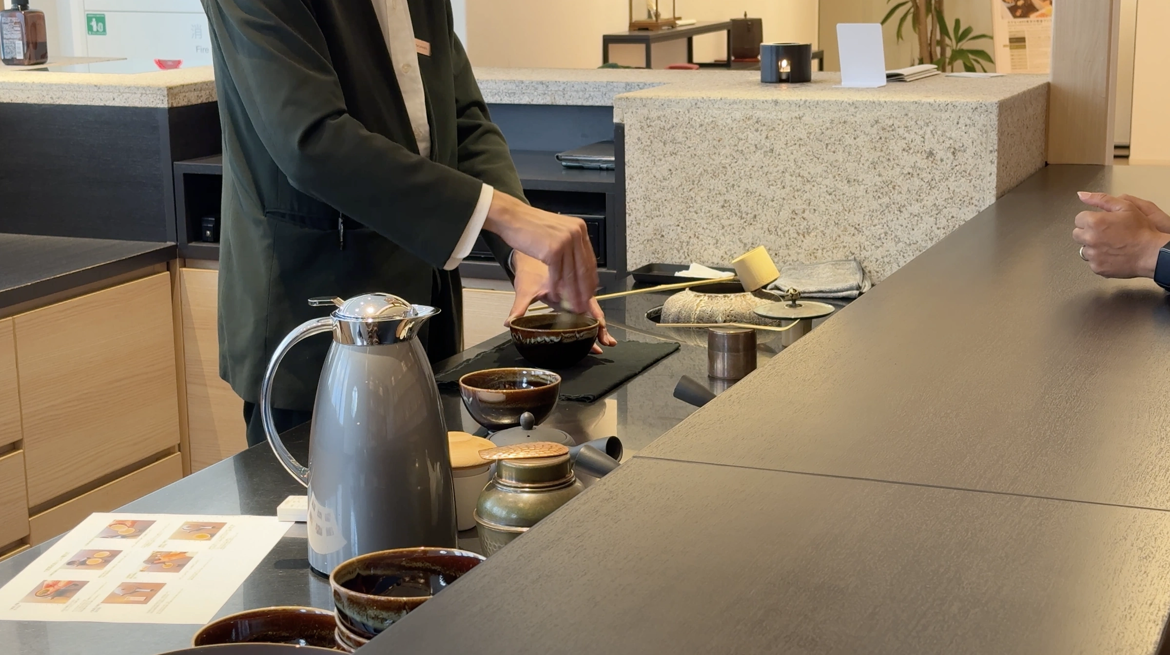 A staff member preparing matcha at the Hotel 1899 Tokyo Tea Counter