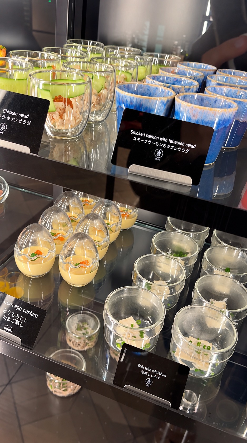 Individual salads, corn egg custard and tofu dishes on the breakfast buffet