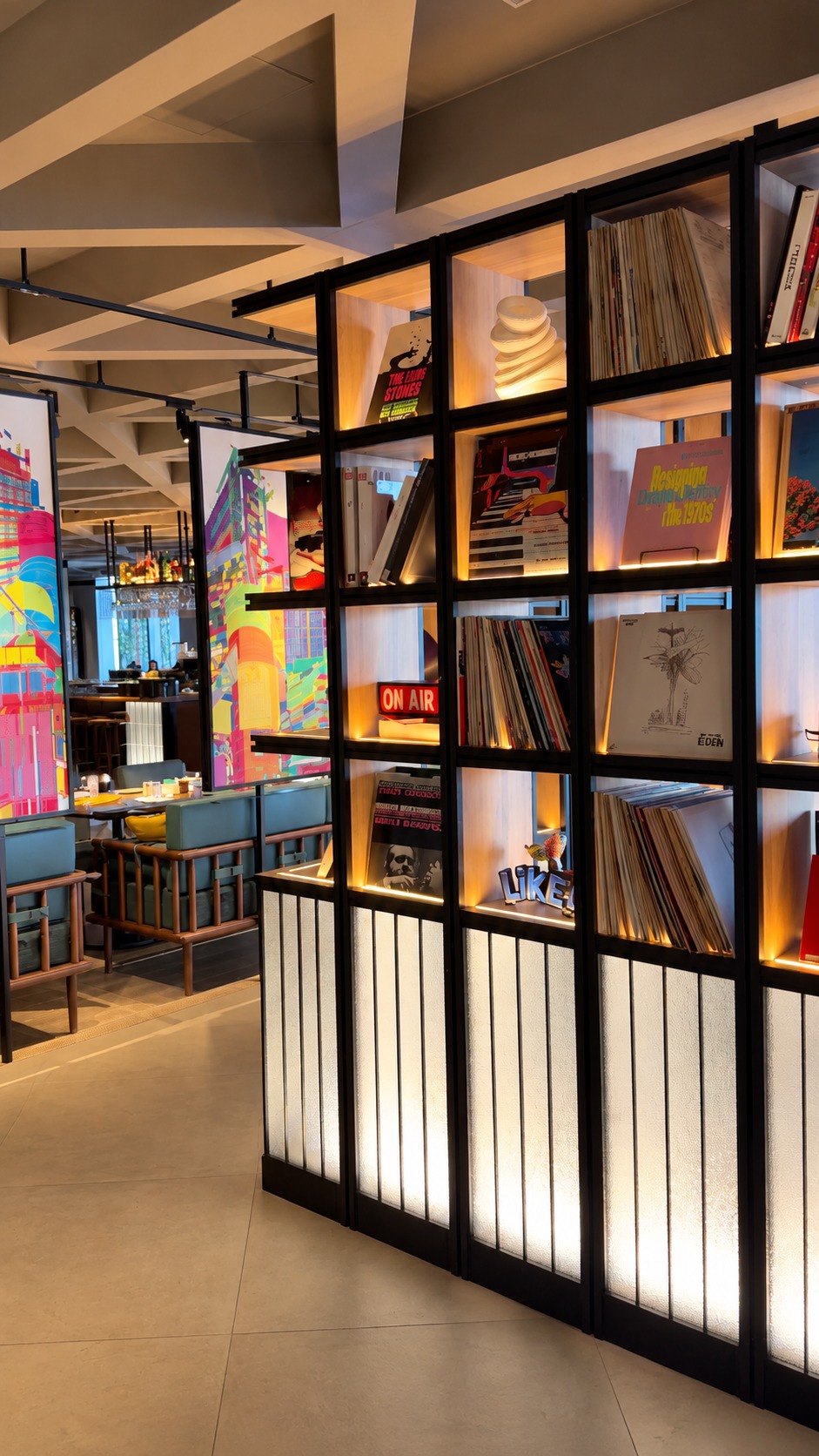 Illuminated vinyl record shelves and colorful seating inside Gallery 11