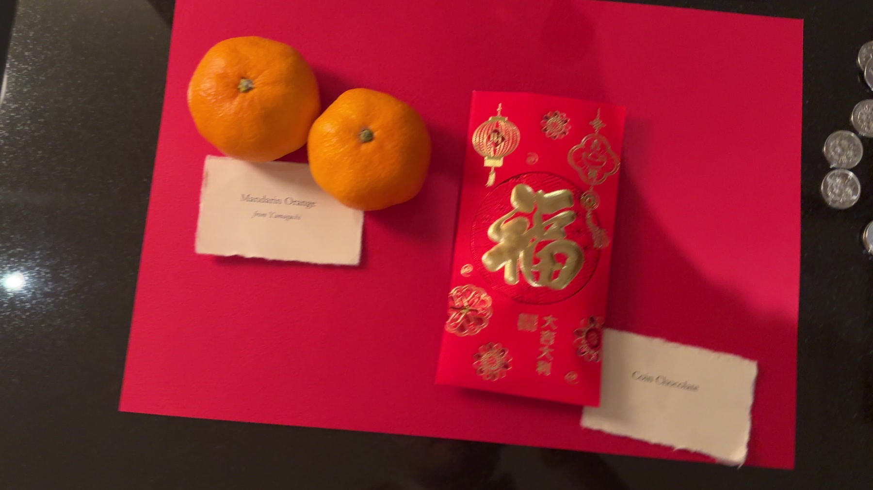 Mandarins, red envelopes and chocolate coins left in our room