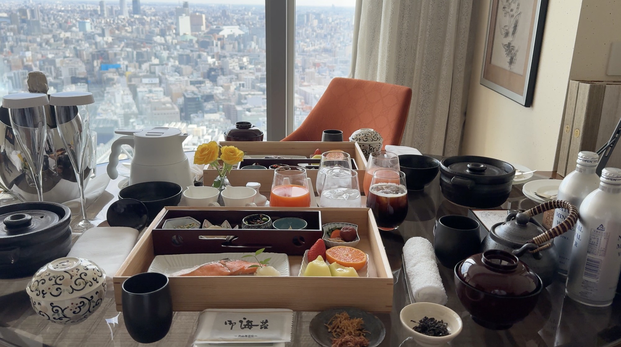 Japanese breakfast served in wooden trays beside the window in our Mandarin Oriental Tokyo room