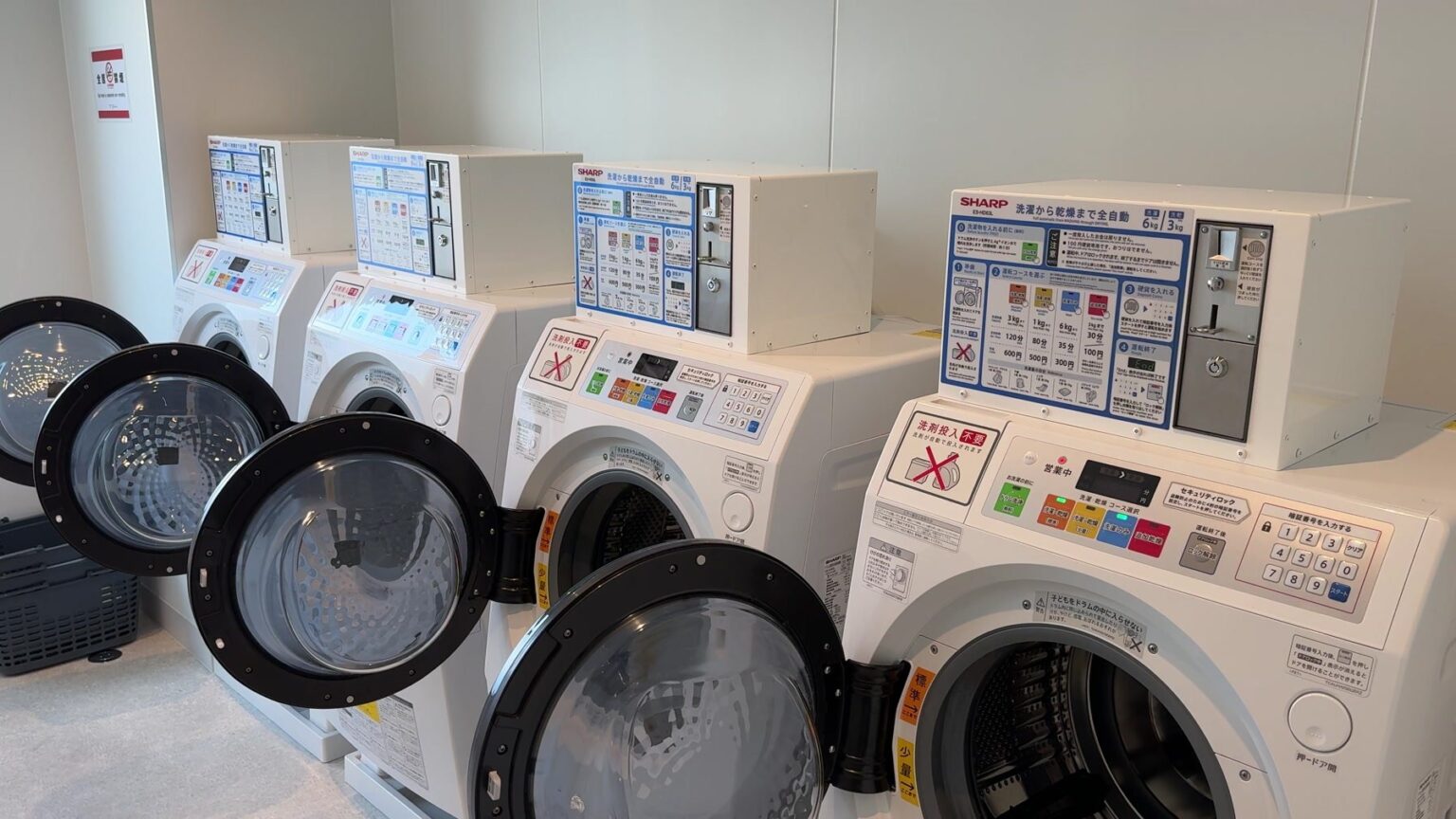 Row of shared washer-dryers at PRIMEHOTEL IMABARI