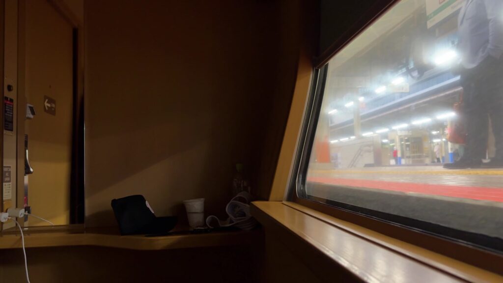 Night-time platform passing the window of our private Sunrise Express cabin